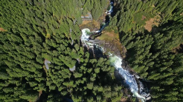 Aerial top view of Krimml Waterfalls in forest mountain. High Tauern National Park, Austrian Alps, Austria, 4k
