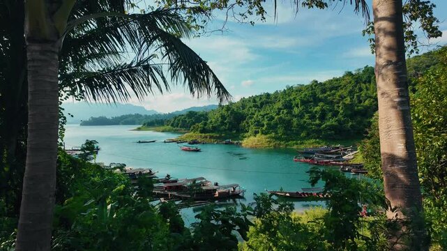 Khao sok national park lake view from boat in Thailand. Tracking shot of wooden boat bow gliding across mountain lake.