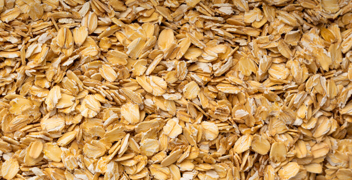 Oat flakes textured pattern, rolled oatmeal macro background