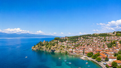 Naklejka premium Historic town by Ohrid Lake with red rooftops and clear blue water