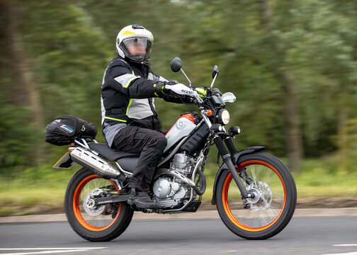 Stony Stratford,Bucks,UK - June 7th 2026:  Man riding a  Yamaha Tricker XG250  motorcycle driving on a British road