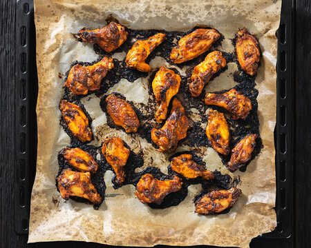 Char-grilled chicken wings on a parchment paper