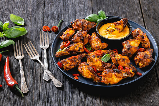 Appetizer chicken wings and creamy dip on a plate