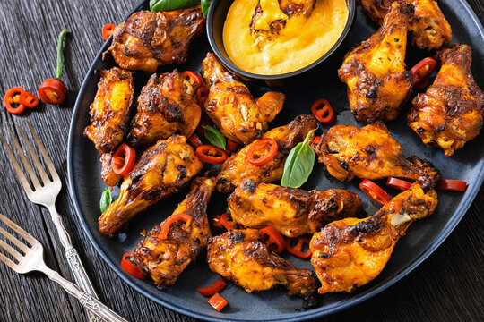Crispy chicken wings with dipping sauce on plate