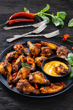 Roasted chicken wings with savory dip, top view