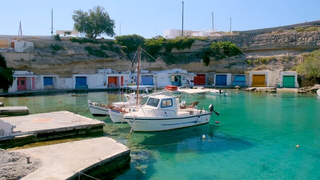 Explore the captivating beauty of Mandrakia village Milos, Greece, where vibrant fishing boats bob in turquoise waters