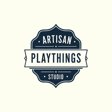 Classic vintage shield badge with heraldic for Artisan Playthings Studio creative toy logo design