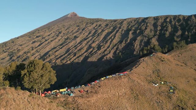 Tents Line Mount Rinjani Ridgeline At Sunset Peak Visible In Background Drone Track In 4K 30FPS