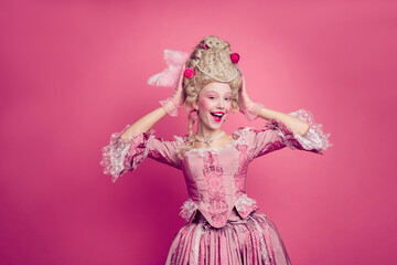 Fototapeta premium Photo of excited girl castle court lady prepare for ballroom dance wear wig medieval style costume isolated pink color background