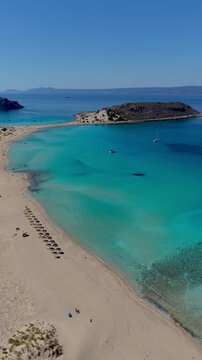 Experience the stunning turquoise waters and golden sands of Simos Beach on Elafonisos Island Greece. This enchanting location is perfect for sunbathers, swimmers, and nature lovers alike.