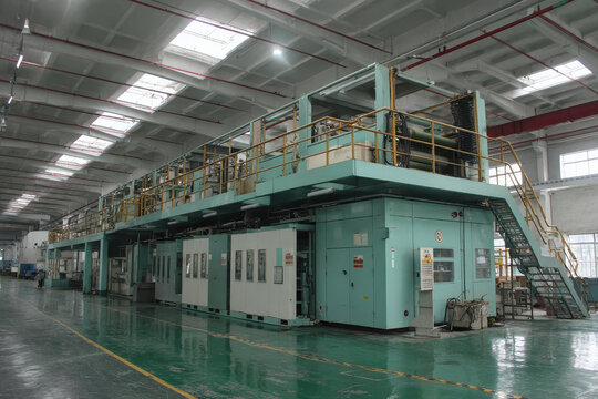 The expansive factory showcases a large printing press used for industrial production, with focus on machinery, equipment, and manufacturing