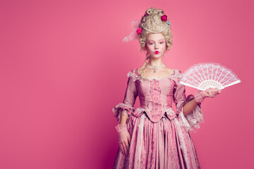 Fototapeta premium Photo of adorable lovely marie antoinette wear corset dress holding hand wig empty space isolated pink color background