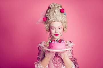 Fototapeta premium Photo of gorgeous excited lady dressed pompous rococo costume enjoying tasty cake empty space isolated pink color background