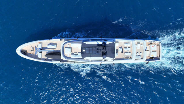 Aerial drone photo of luxury yacht cruising in deep blue open ocean Aegean Sea