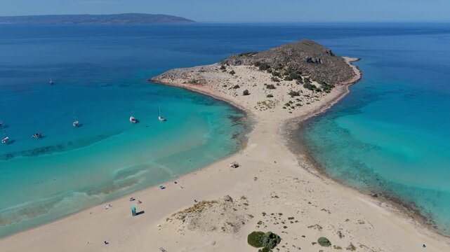 Discover the stunning landscape of Simos Beach Elafonisos in Greece. Clear blue waters meet golden sands, inviting travelers to relax in a tropical paradise under the bright sun.