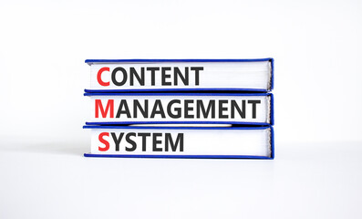Fototapeta premium CMS content management system symbol. Concept words CMS content management system on beautiful books. Beautiful white background. Business CMS content management system concept. Copy space.