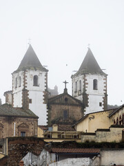 Fototapeta premium Towers of the Church of Saint Francis Xavier in Cáceres (Extremadura) with thick fog