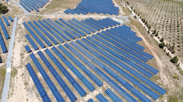 Aerial view flying over a solar farm generating renewable energy
