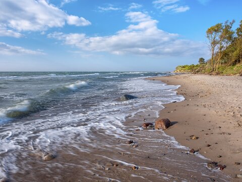 Natural secluded stretch of coast with surf on the beach of the stormy Baltic Sea, foam crowns on the waves, near Rerik, Mecklenburg-Western Pomerania, Germany