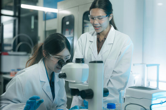 ecologists testing wastewater purity using scientific equipment in sterile cleanroom, environmental sustainability concept.