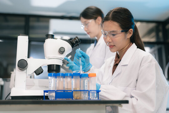 ecologists testing wastewater purity using scientific equipment in sterile cleanroom, environmental sustainability concept.