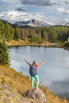 Young hiker at a lake, Fourth Lake, Valley of the Five Lakes, Jasper National Park, back mountains, Alberta, Canada