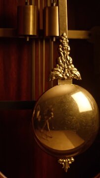 Close-up of a vintage pendulum clock's ornate pendulum swinging gently. Represents timeless elegance and the art of craftsmanship in timekeeping