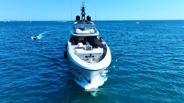 Aerial drone cinematic video of luxury yacht with wooden deck cruising in deep blue Mediterranean Sea