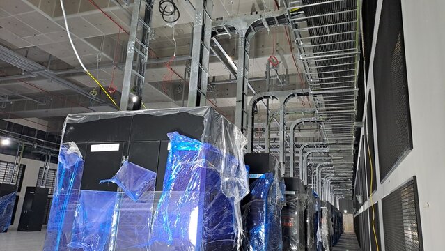 Industrial PDU cabinets and complex cable trays inside a data center under construction