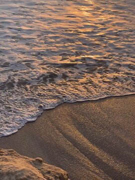 Golden Sunset Waves on Sandy Beach Shore in Nazar&eacute; Portugal