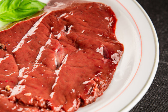 Raw liver offal pork or beef meat lunch or dinner tasty snack organic fresh and delicious gourmet food background on the table rustic food top view copy space