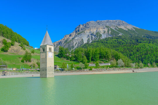 Reschen am See, Resia, Church Tower from Altgraun, Medieval church bell tower rising from a lake, the surviving remains of a reservoir-flooded village., Italy