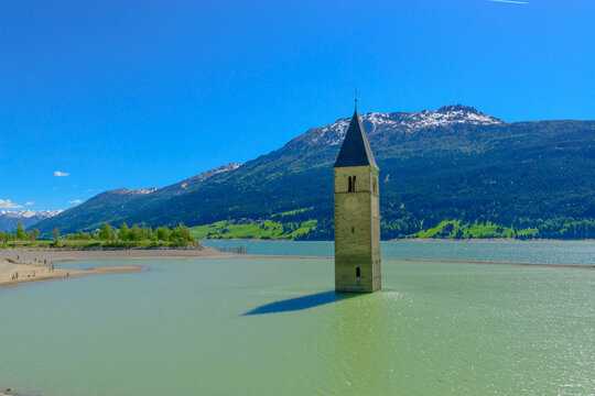 Reschen am See, Resia, Church Tower from Altgraun, Medieval church bell tower rising from a lake, the surviving remains of a reservoir-flooded village., Italy