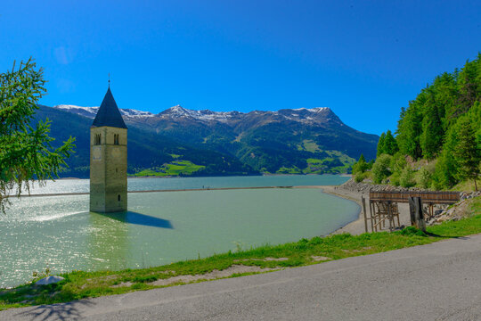 Reschen am See, Resia, Church Tower from Altgraun, Medieval church bell tower rising from a lake, the surviving remains of a reservoir-flooded village., Italy