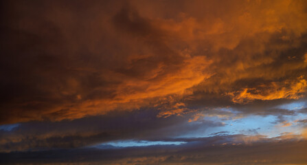 Fototapeta premium Sunset sky with orange clouds. Nature background.