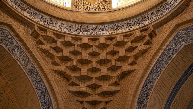 Intricate brick squinch supporting a dome in an Islamic mosque.