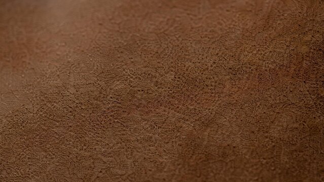 Extreme close-up of nubuck leather texture showing fibrous structure under natural window light.