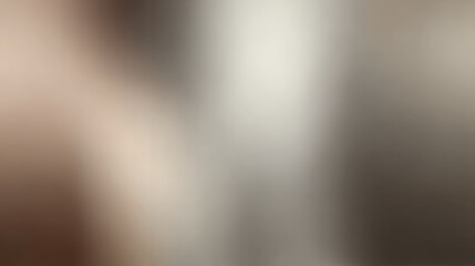 Fototapeta premium Subdued abstract blurred gradient background in muted neutral tones of grey, brown, and beige with smooth lighting transitions