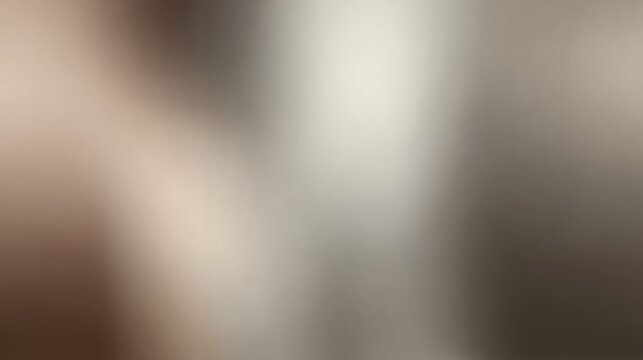 Subdued abstract blurred gradient background in muted neutral tones of grey, brown, and beige with smooth lighting transitions