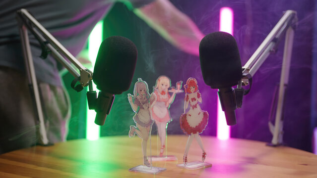 Person set up green and purple neon tubes on anime manga podcast studio