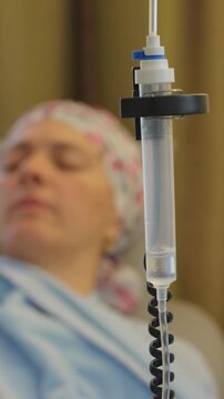 Chemotherapy infusion chamber with visible medication drops falling through intravenous line highlighting precision oncology treatment controlled drug delivery