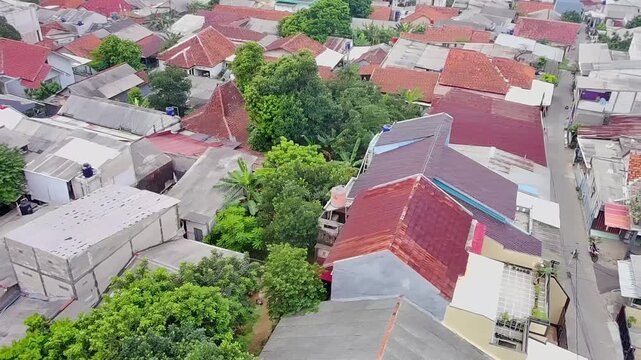 Aerial Drone View of Dense Residential Neighborhood with Red Roof Houses in Urban Indonesia