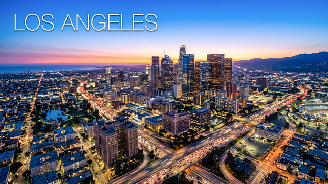 A vibrant evening panorama of Los Angeles, showcasing the illuminated skyscrapers and bustling freeway system as the sun sets over the distant mountains