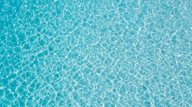 Top down view of pure light turquoise water surface texture with sun reflections and gentle ripples for summer background