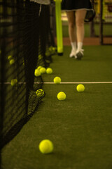 Padel balls on the green court, clean and minimalistic background image for sports websites, blogs, and promotional materials. © Mike Orlov