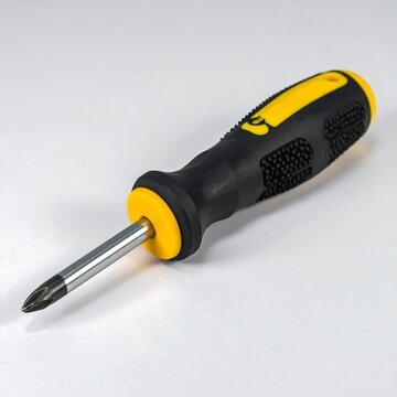 Black and Yellow Phillips Screwdriver Resting on White Surface