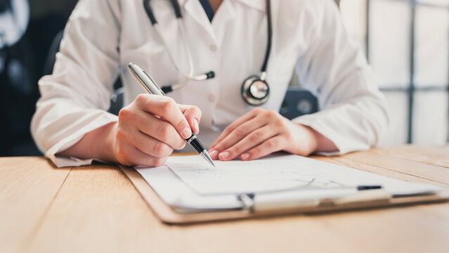 Medical doctor completing administrative healthcare records
