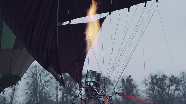 Hot air balloon festival, evening winter burner fills the balloon with warm air close-up