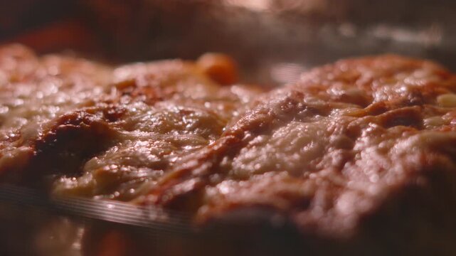 Bubbling Spicy Mexican Chicken Enchiladas Cooking on High Heat in Oven. Indulgent Cheese Melting.