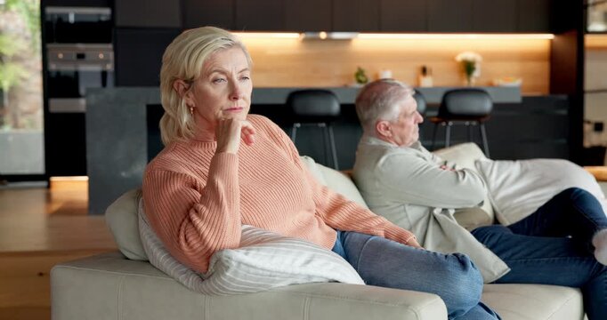 Elderly, couple and ignore with separation on sofa for argument, fight or conflict together in home. Senior, man and frustrated woman with arms crossed for disagreement, toxic marriage or dispute